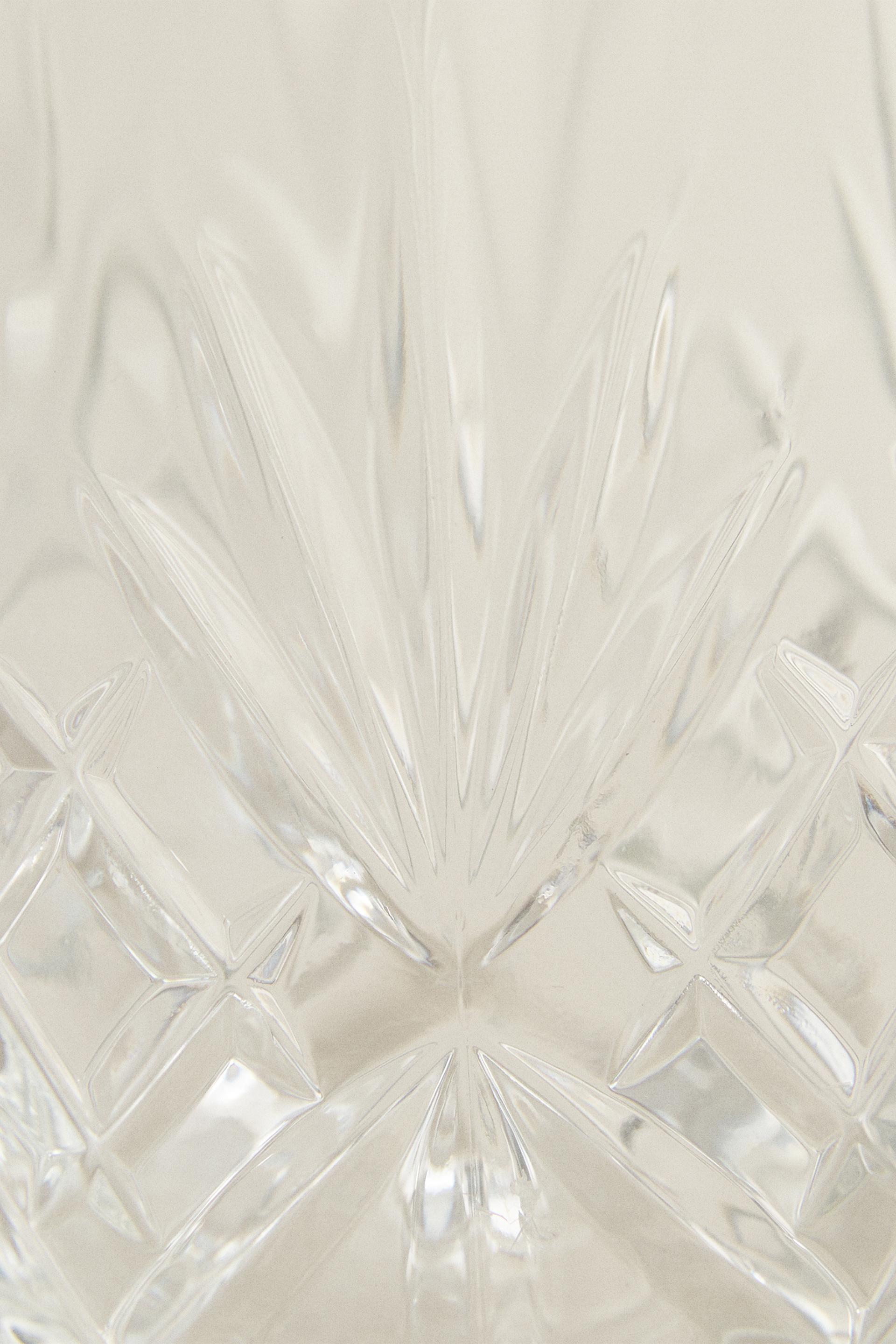 CRYSTALLINE TUMBLER WITH RAISED DESIGN